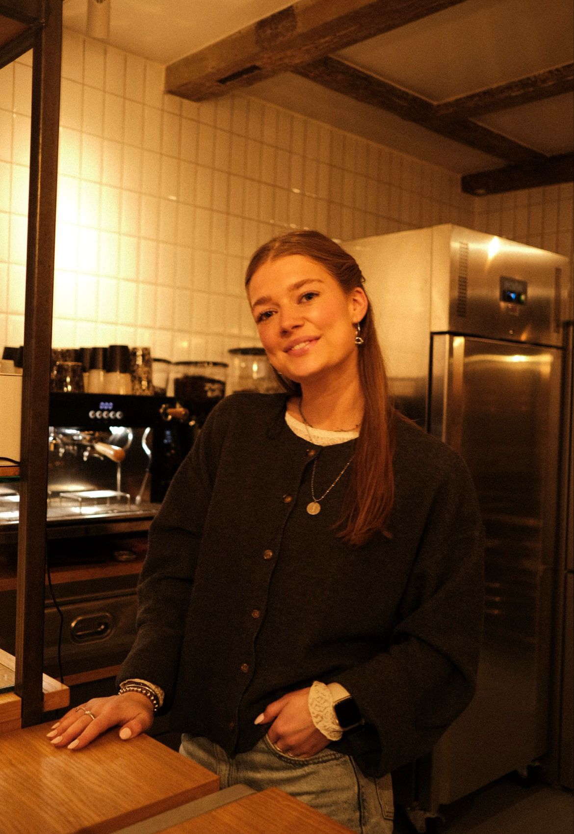 Girl smiling behind the bar at JUULZ